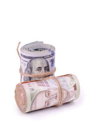 Tubes of United States Dollars and Ukrainian Hryvnia UAH Banknotes Isolated on a White. Financial business background.の写真素材