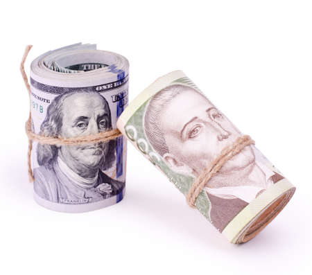 Tubes of United States Dollars and Ukrainian Hryvnia UAH Banknotes Isolated on a White. Financial business background.の写真素材
