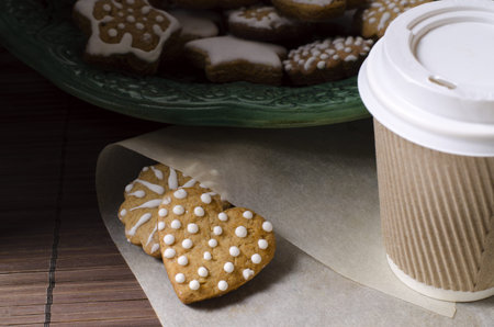 Gingerbread cookies and take away coffee.の写真素材