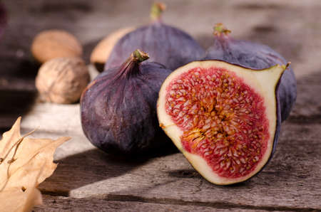 Ripe fresh sweet figs close up. Fresh fig fruit on a old brown wooden table.の写真素材