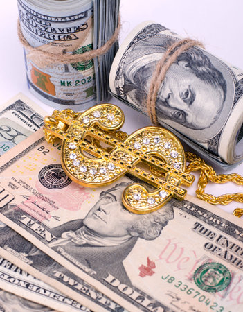 Gold Dollar Sign Necklace on a United States Dollars Banknotes. Financial business background.
