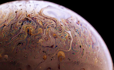 Abstract macro of soap bubble. Close up surface of soap bubble seems like planet in space. Bright creative background.の写真素材