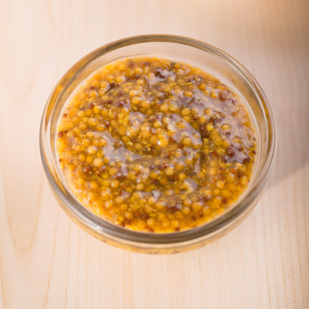 Bowl dijon mustard in glass bowl top view