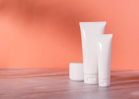 Skin Care Cosmetics bottle and jar with cream on a marble background. Mockup of natural cosmetics packagingの写真素材