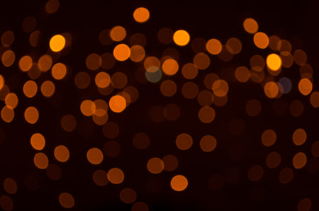 Plenty of golden sparkling bokeh from defocused garland lights. Backdrop for design. Bright...