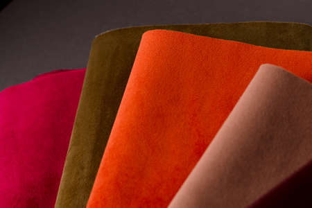 A bright collection of red, brown and orange colorful velor textile samples. Fabric texture backgroundの写真素材