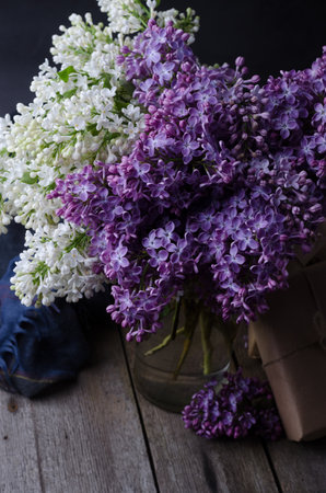 Closeup Purple lilac flowers on a old wooden surface. Spring floral background.の写真素材