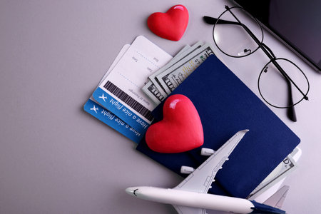 Romantic Airplane Travel preparation Concept objects, documents, dollars, passports, boarding pass tickets, glasses, smartphone, and space for text.の写真素材