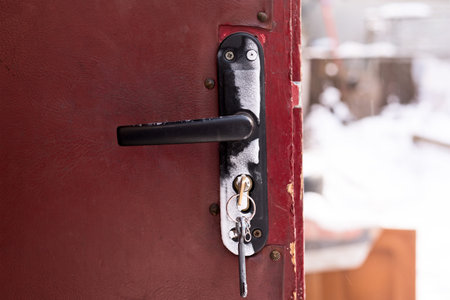 Frozen door lock on old brown doors.