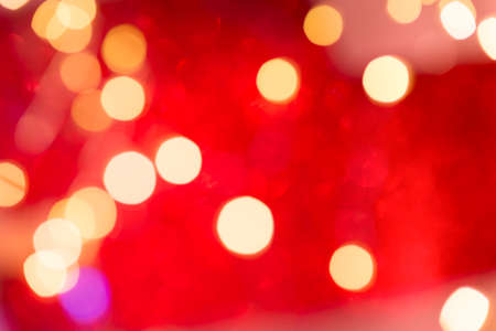 Beautiful red color bokeh background. Happy New Year and Christmas backdrop with sparkling bokeh.の写真素材
