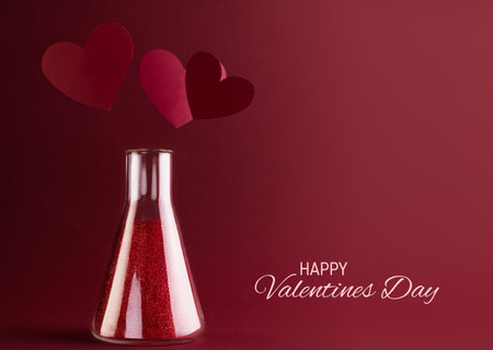 Love Chemistry, Happy Valentines Day card with Sparkling potion in Laboratory Glass Flask and Red hearts above it.の写真素材