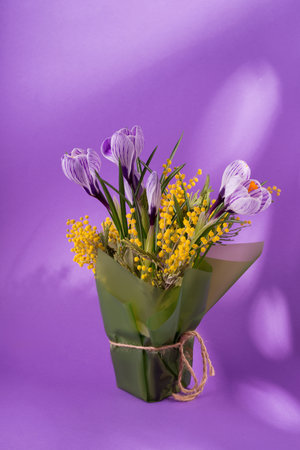 Beautiful spring bouquet of crocuses and mimosa flowers.の写真素材