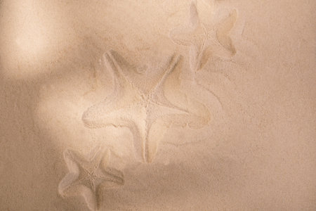Starfish trace on a sand surface. Summerbackground good for Seasonal Sale or Tour Trip announce.