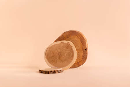Natural wooden podiums against sand color background.の写真素材