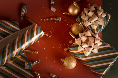 Boxing Day concept with gift boxes in gold and green colors decorated with sparkling bow against...