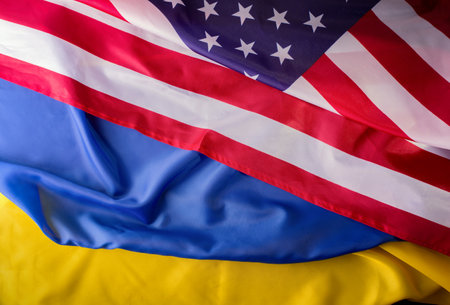 United States of America and Ukrainian flags together on one picture. Ukraine and US Partnership during war of 2022 conceptの写真素材