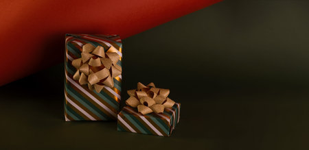 Boxing Day concept with gift boxes in gold and green colors decorated with sparkling bow against...