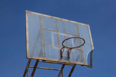 An old basketball hoop consumed by games and matchesの写真素材