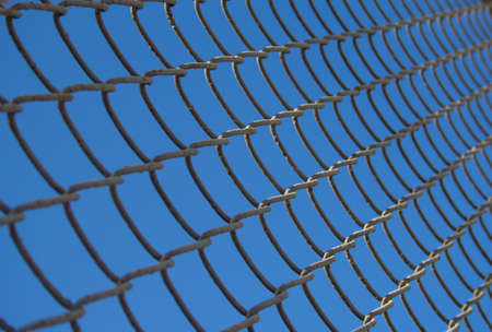 close up of metal wire mesh in blue skyの写真素材