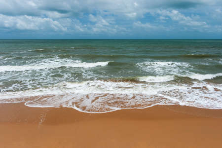tropical beach with waves and sandの写真素材