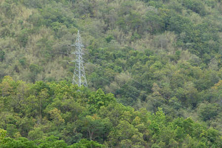 high voltage transmission towers on mountainの写真素材