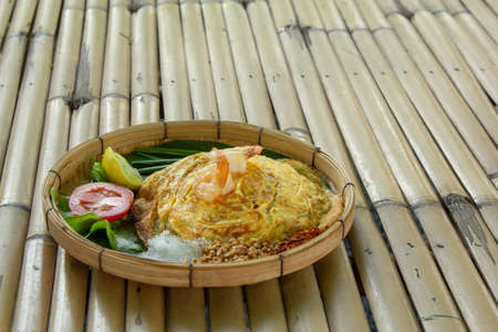 fried noodle Thai style with prawns, stir-fried noodle Thai style on bamboo table backgroundの写真素材