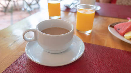 closeup cup of coffee on wooden tableの写真素材