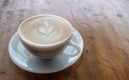 closeup cup of coffee on wooden tableの写真素材