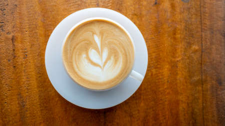 top view of coffee latte on wooden tableの写真素材