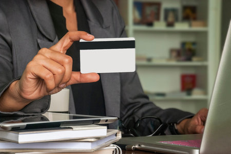 businesswoman shopping online with a laptop on the table using a credit card to buy online.