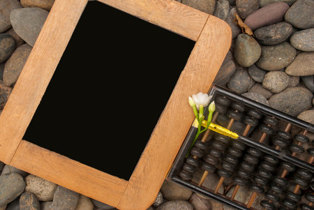 Abacus and slate paper placed on granite From the top view