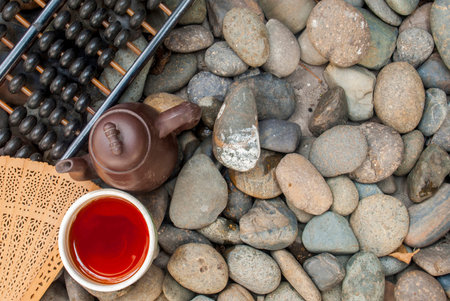 Chinese tea set with abacus and Chinese fan set on granite pile Suitable for making background imagesの写真素材