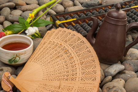 Chinese tea set, abacus, Chinese fan, flowers placed on granite blocks Suitable for making...