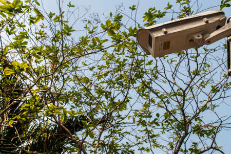 Modern surveillance cameras on the cityscape background wall, the concept of surveillance and visual inspection that has been developedの写真素材