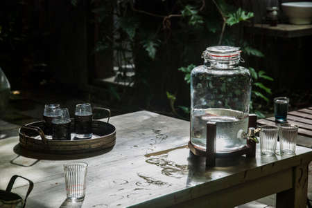 Glass jar with water and a glass of water placed in Ruen Thai, Thailandの写真素材