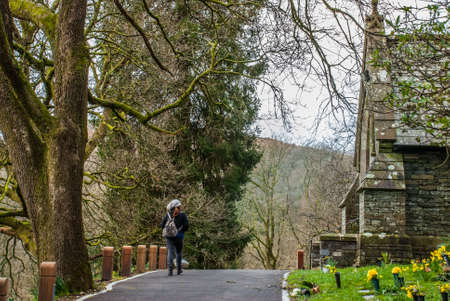 Women who visit the beautiful old stone church on the mountainの写真素材