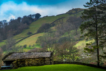 Landscape with English countryside of sheep on the hillsideの写真素材