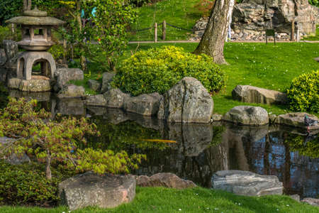 Japanese garden decorated with Japanese stone lanterns, flowers and stone floors Beautiful and calm.の写真素材