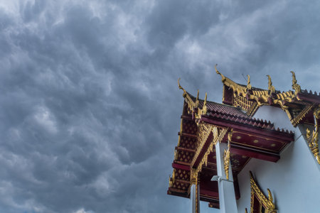 The roof of the Thai temple, along with the gable at the top of the church with a sky backdrop...
