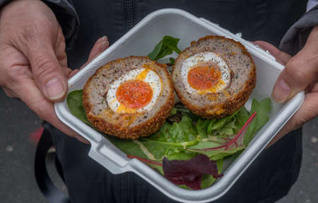 Breakfast of Scotch eggs and traditional vegetable salad (pork and soups) in the borough market.の写真素材
