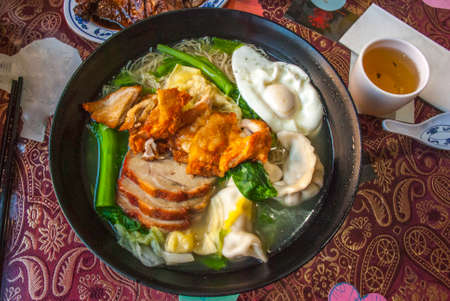 Red pork noodles, fried chicken, dumplings, fried eggs, vegetables and soups, Chinese foodの写真素材