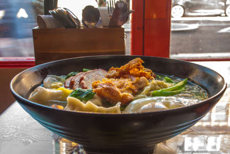 Red pork noodles, fried chicken, dumplings, fried eggs, vegetables and soups, Chinese foodの写真素材