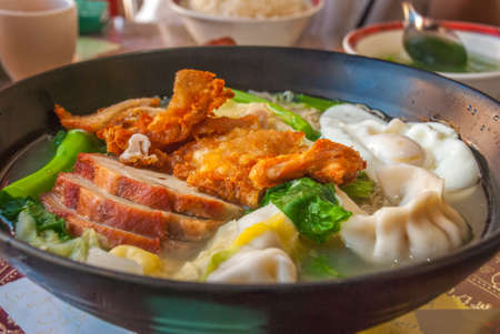 Red pork noodles, fried chicken, dumplings, fried eggs, vegetables and soups, Chinese foodの写真素材
