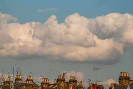 The roof of the house has a backdrop of beautiful sky and white clouds in Hampstead Heath.の写真素材