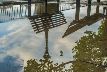 Reflections in the water of the path banks of the River Thames after rain. Suitable for background images.の写真素材
