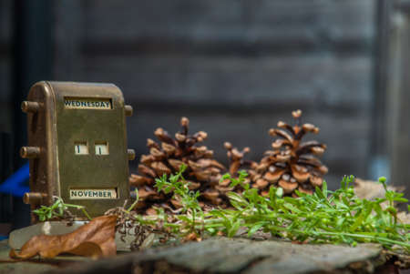 Antique Brass Desktop Perpetual Calendar on an Old wooden floor.の写真素材