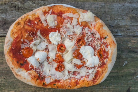 Pizza margherita on the wooden table.