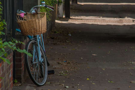 London - May 5, 2019 - A bicycle parked on the sidewalk in front of old red brick lofts in the city center, chiswick neighborhood, UKの写真素材