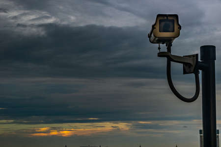 bangkok,Thailand - jun 26, 2019 :  CCTV monitoring, security cameras. Backdrop with sky and clouds during beautiful  twilight.の写真素材