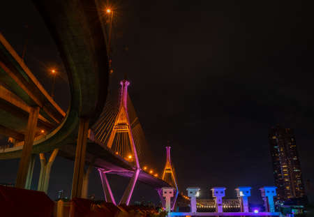 Bhumibol Bridge also casually call as Industrial Ring Road Bridge with floodgate illuminate with spotlight at night scene, Samut Prakarn, Thailandの写真素材